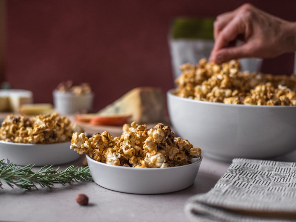 Candied rosemary popcorn with hazelnuts in a 3 bowls